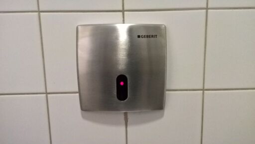 Picture of urinal autoflush sensor, resembling iconic HAL9000 eye.