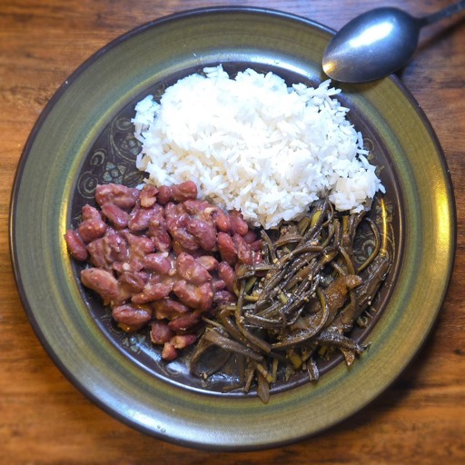 A green plate of food on a wooden surface