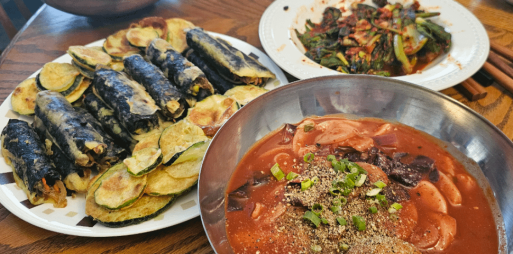 Tteokbokki, kim mari, bok choy kimchi, and hobak jeon